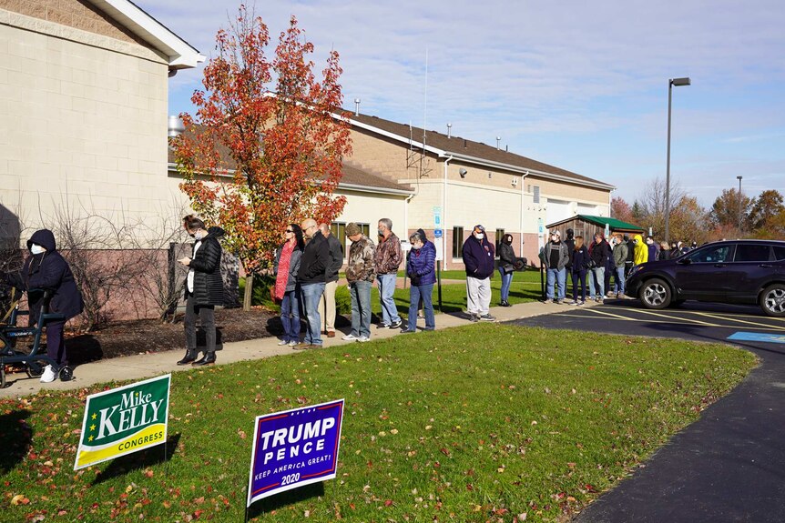 voters wait in line outside in Pennsylvania to vote in the US presidential election