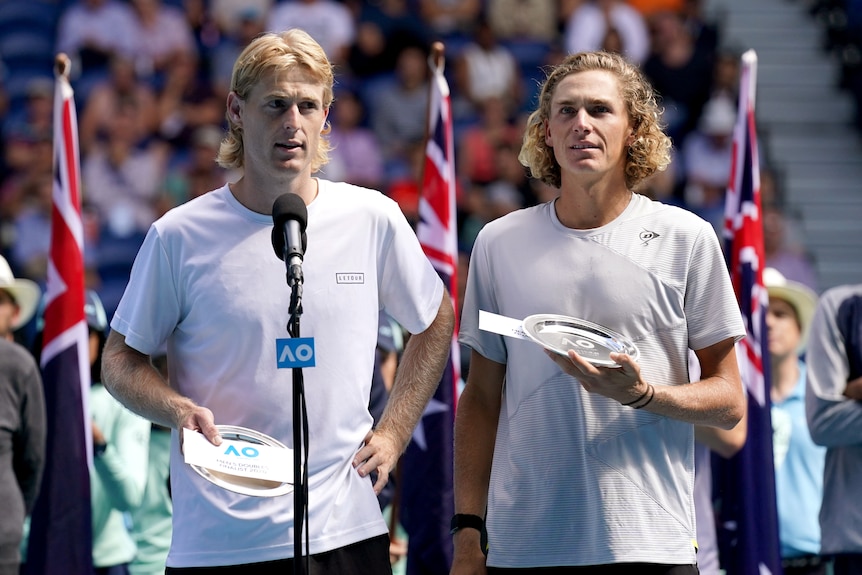 Luke Saville and Max Purcell look circumspect as they hold their runners-up plates
