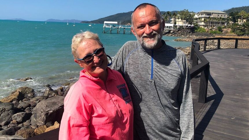 Dr John Hadok and his wife Janice Quadrio standing near the water at Airlie Beach.