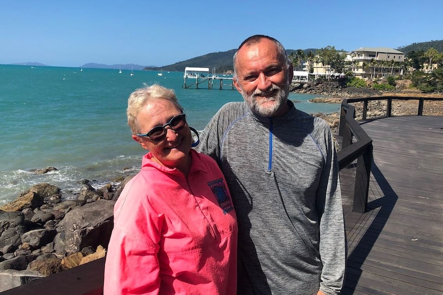 Dr John Hadok and his wife Janice Quadrio standing near the water at Airlie Beach.