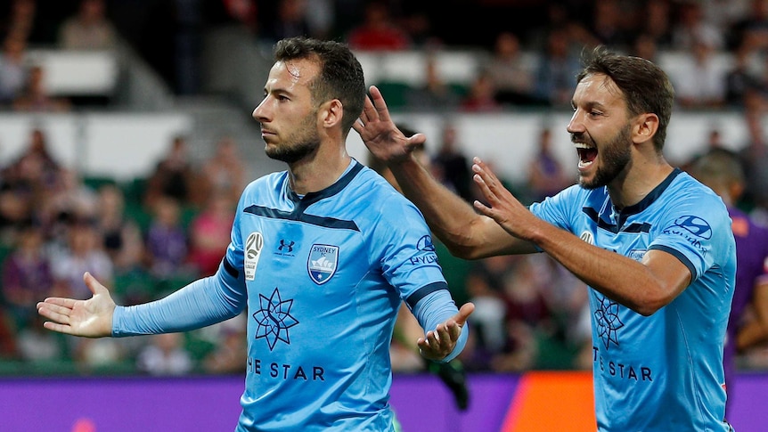 Adam le Fondre celebrates by holding his arms out nonchalantly as Milos Ninkovic runs behind him