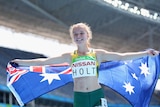 A female Paralympian smiles at the camera while posing with the Australian flag after winning a silver medal in Rio. 