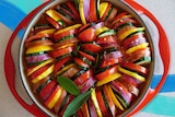 Slices of vegetables in a baking tray ready to be baked into a vegetarian side for a sharing.