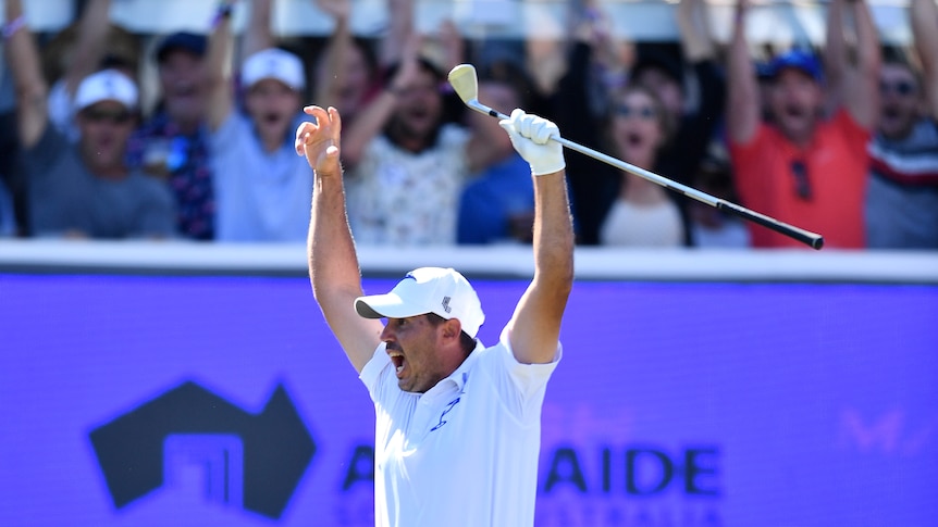 A US golfer jumps up as he celebrates a hole-in-one