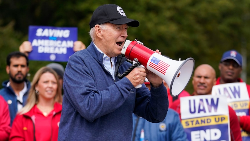 Biden shouts into a megaphone.