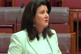 Jane Hume tears up in the Senate as she discusses her father's death.