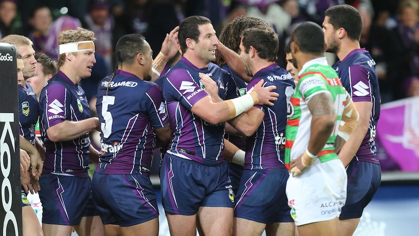 Melbourne Storm players celebrate a try against Souths