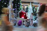 Shoppers walk past Santa in Grand Central Shopping Centre Toowoomba