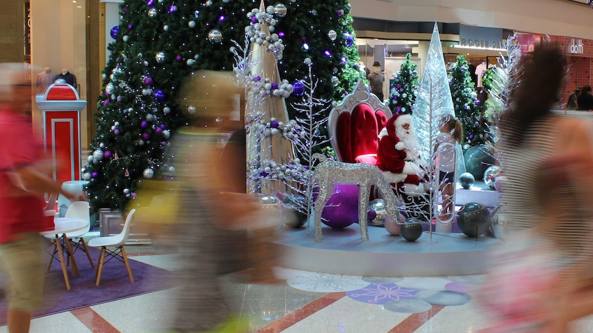 Shoppers walk past Santa in Grand Central Shopping Centre Toowoomba