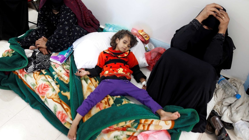 A girl infected with cholera lies on the ground at a hospital in Sanaa, Yemen.