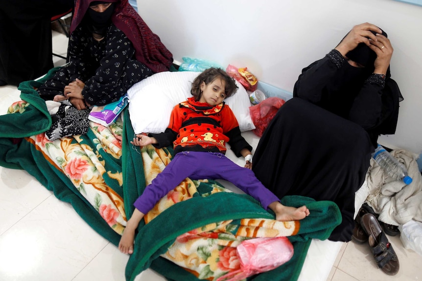 A girl infected with cholera lies on the ground at a hospital in Sanaa, Yemen.