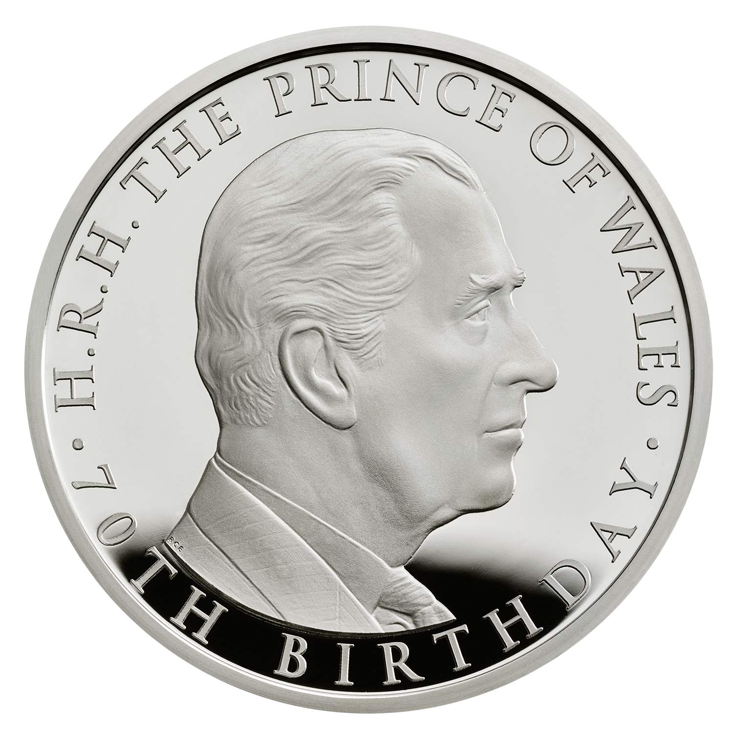 A silver coin with Prince Charles' face engraved on it.