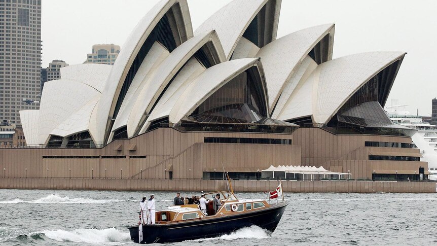 Prince Frederik and Princess Mary pass by the Sydney Opera House in a barge.