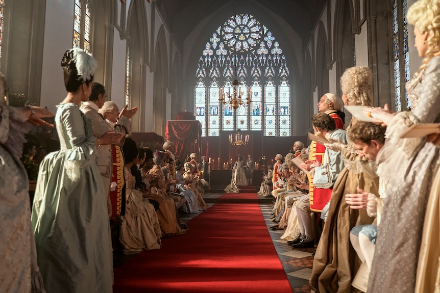 People clap as Charlotte and George get married.