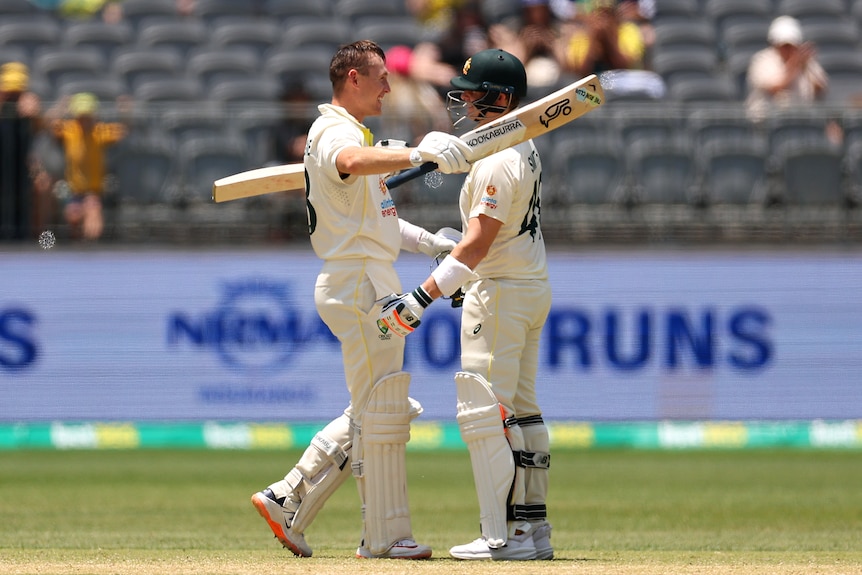 Australia batters Marnus Labuschagne and Steve Smith hug during a Test against West Indies,.