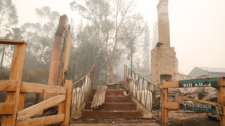 A staircase leading to the remains of a burned building.