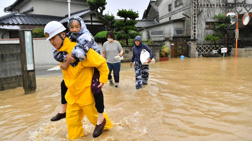 An elderly woman is evacuated to a safer place.