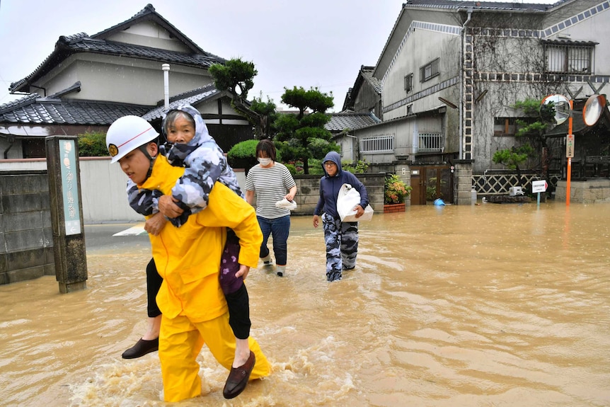 An elderly woman is evacuated to a safer place.