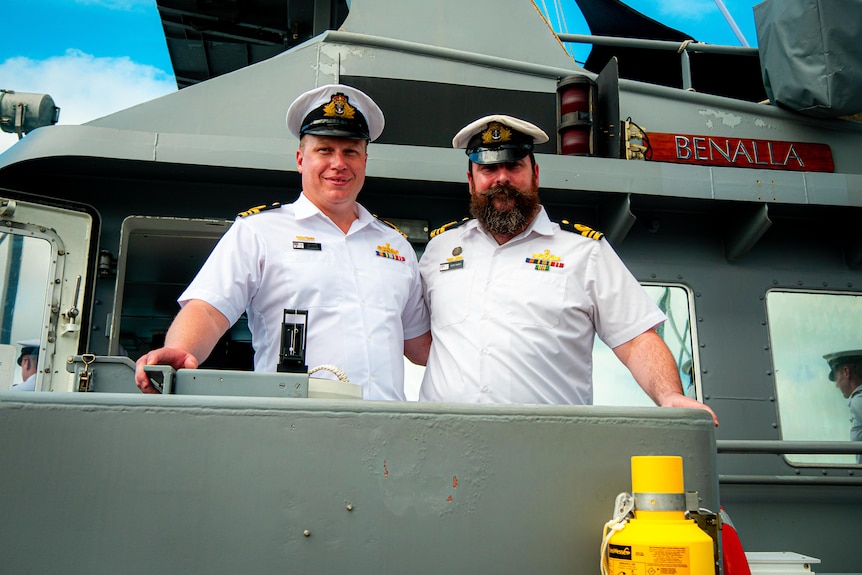 Two naval officers on the bridge of a naval ship.