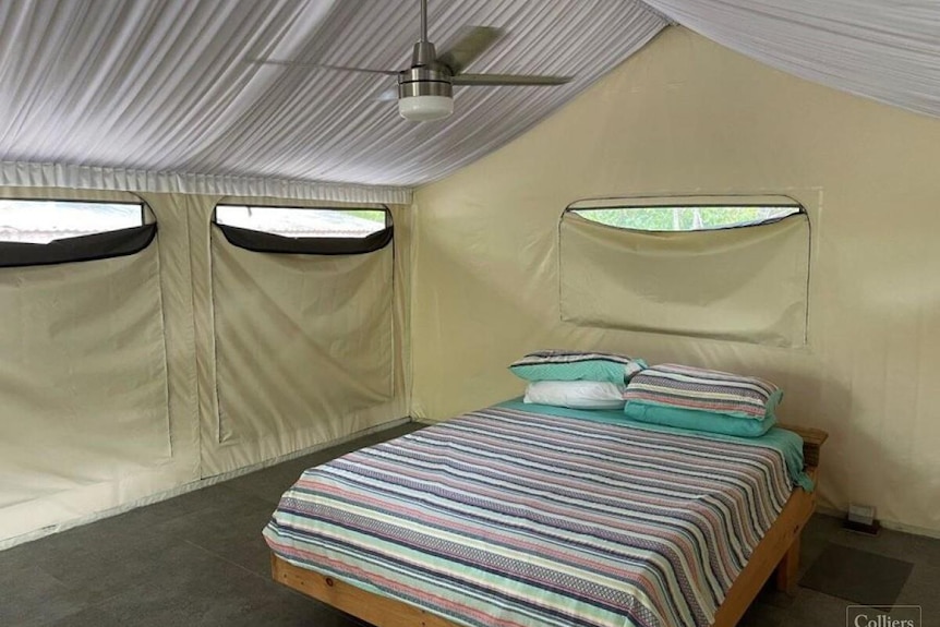 A double bed inside a glamping tent