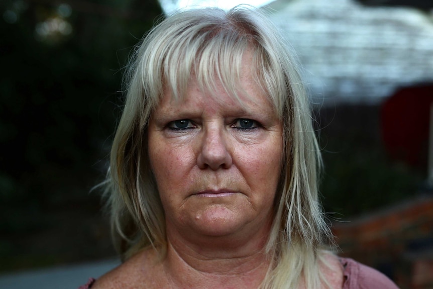 Jane Reynolds in a pink top and blonde hair.