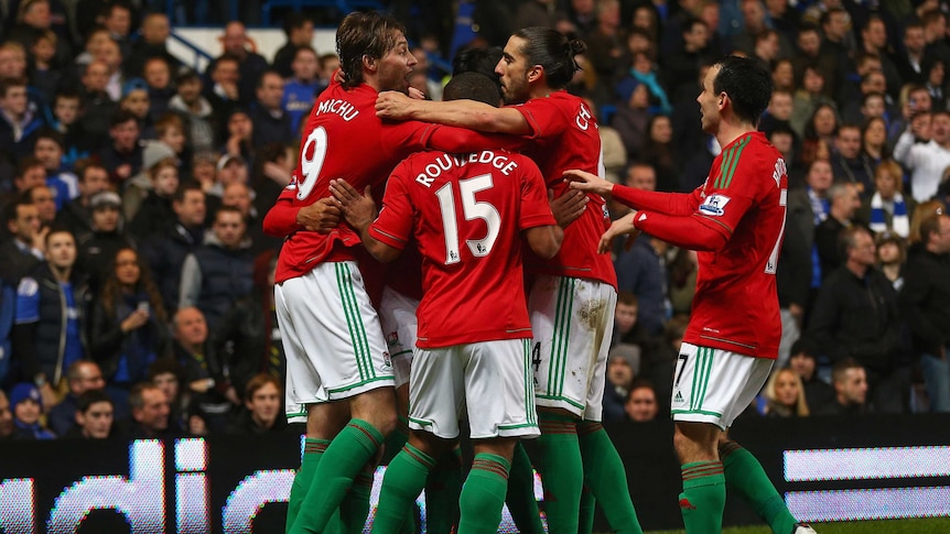 Michu (L) of Swansea City celebrates scoring the opening goal with team-mates during the League Cup semi-final first leg match against Chelsea at Stamford Bridge on January 9, 2013 in London.