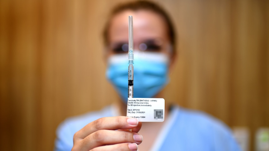 A nurse holding up the Pfizer vaccine