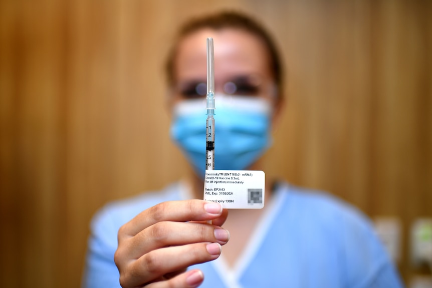 A nurse holding up the Pfizer vaccine