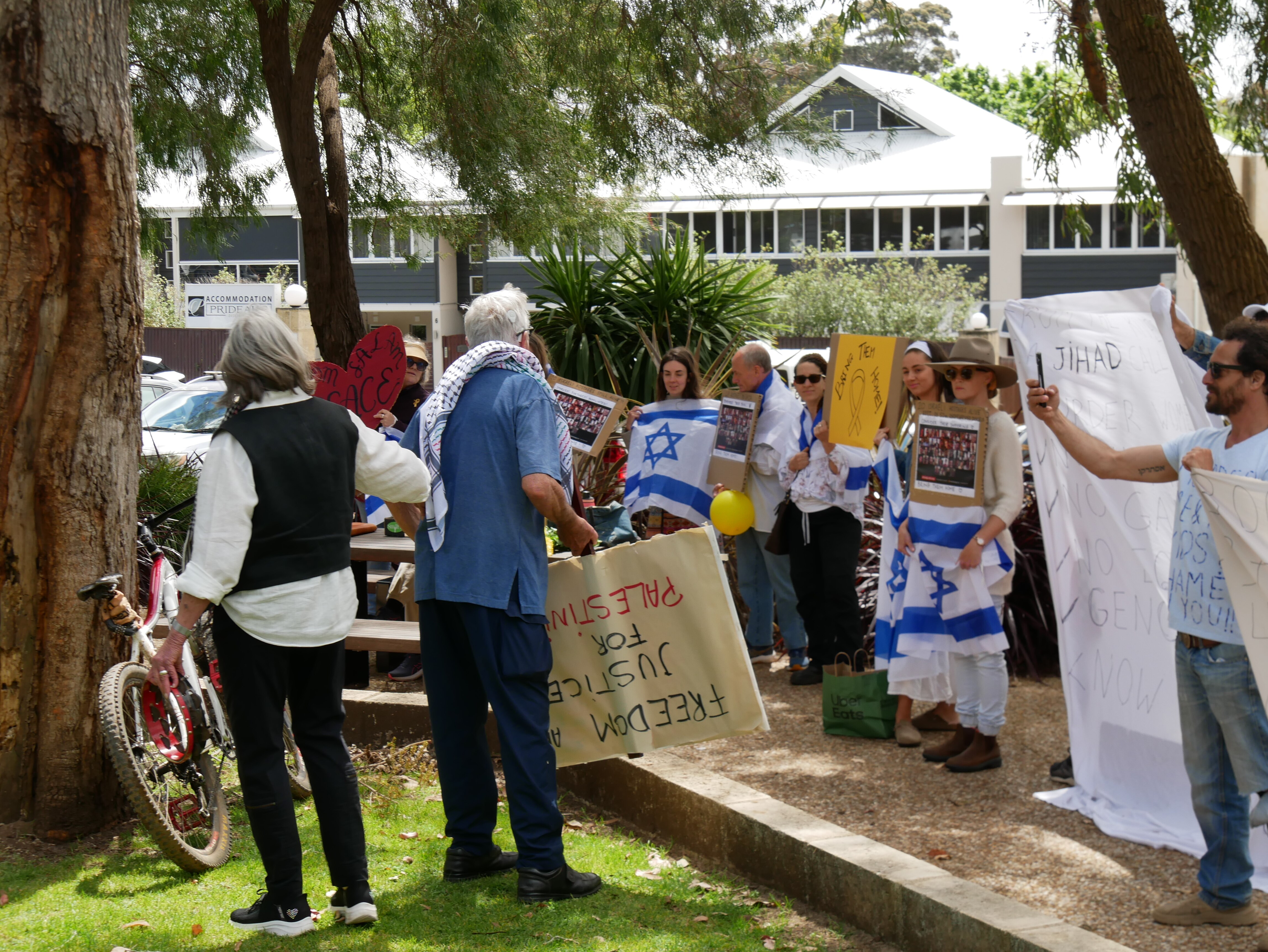 pro israel protesters hold flags at a prop palestine rally in margaret river wa