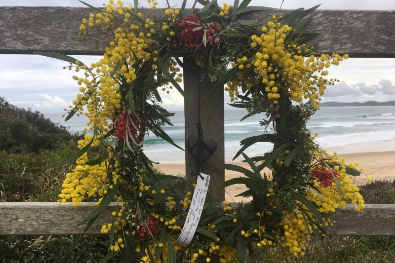 A wreath at Wooli Beach, where Mani Hart-Deville died on Saturday.