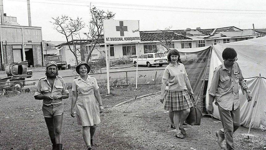 Red Cross workers talk near their headquarters at Lambell Terrace