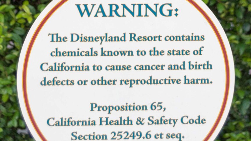 A circular sign saying "WARNING: The Disneyland Resort contains chemicals known to the state of California to cause cancer."