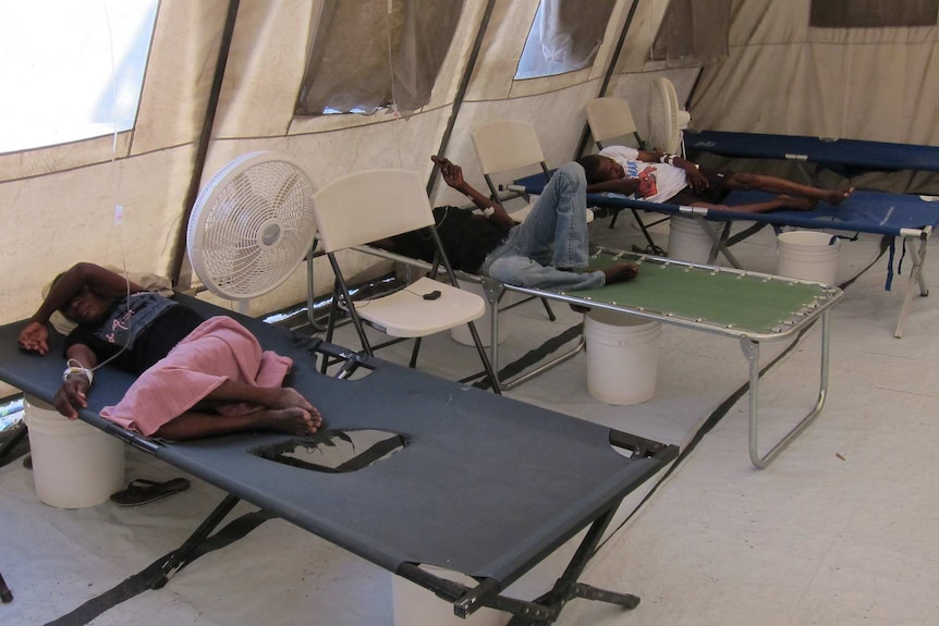 Haitian people lying on stretchers