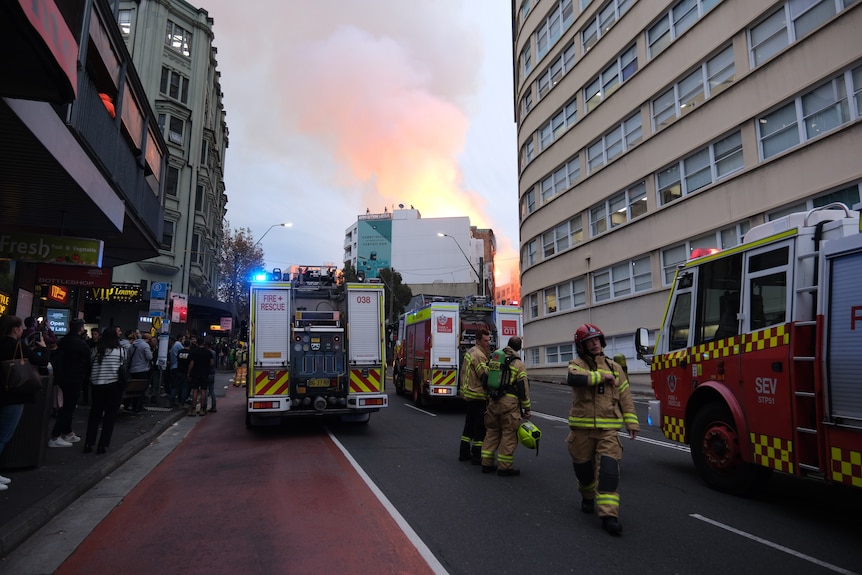 firefighters outside a building that is on fire