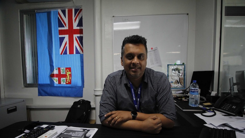 Indra Singh from the Fijian Broadcasting Corporation sitting in his Suva office
