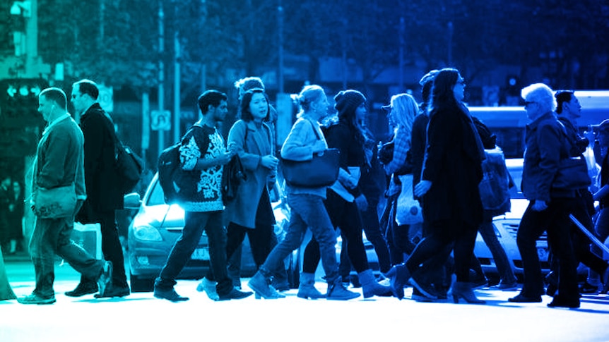 People walk through busy Melbourne street