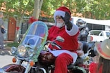 man dressed as Santa on a motorbike