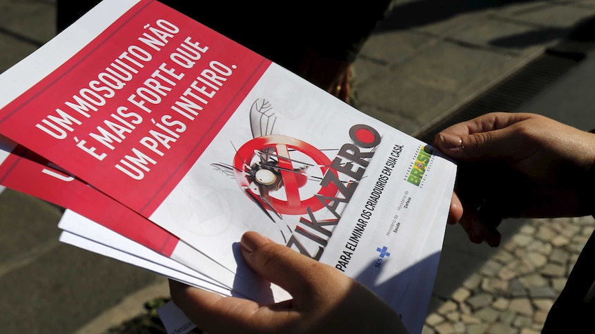 A Brazilian Army soldier shows pamphlets during the National Day of Mobilisation Zika Zero in Rio de Janeiro.