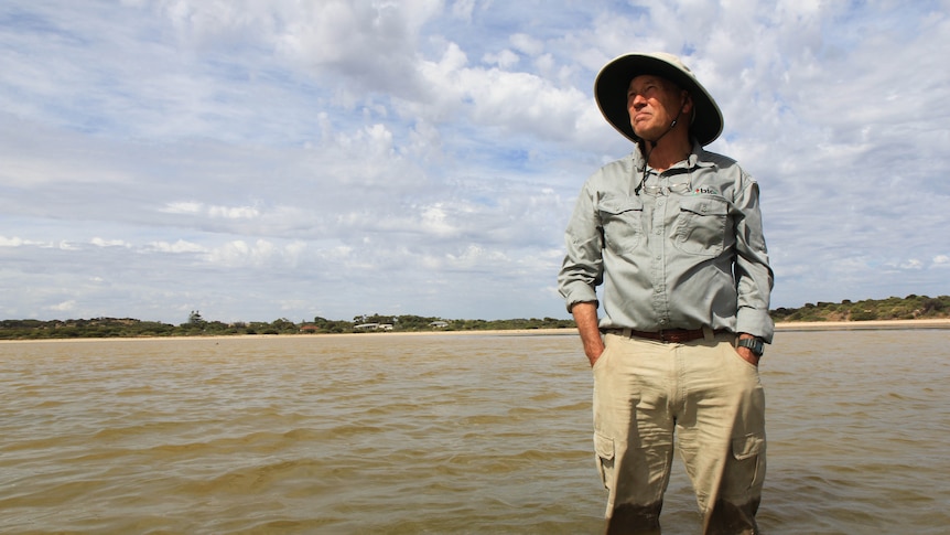 David Paton stands in the coorong river