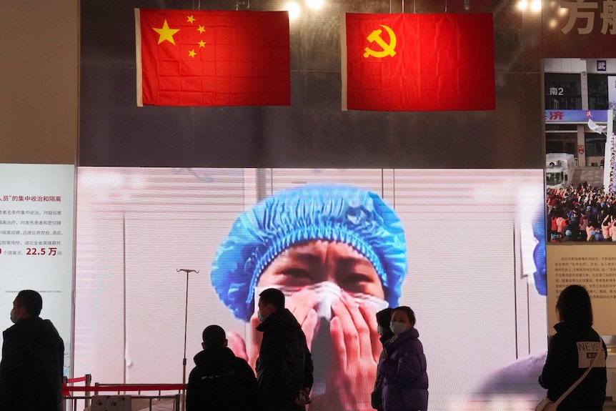 Wuhan residents attend an exhibition on the city's fight against the coronavirus