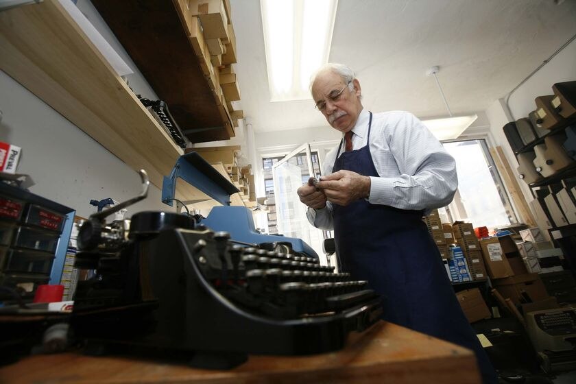Paul Schweitzer works on a typewriter
