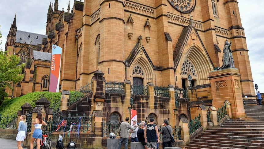 People stand outside St Mary's Cathedral in Sydney