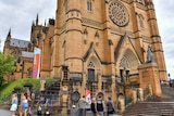 People stand outside St Mary's Cathedral in Sydney