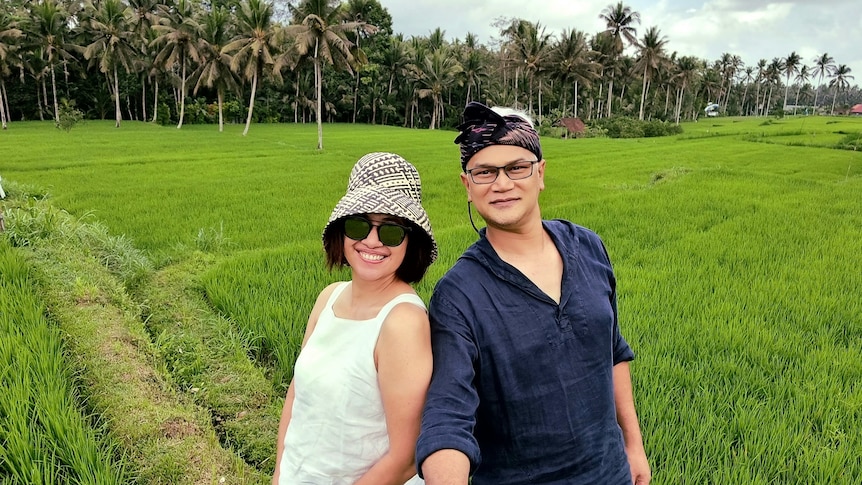 Rahmadian Satari and his wife selfie in front of paddy fields