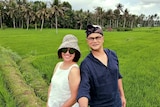 Rahmadian Satari and his wife selfie in front of paddy fields