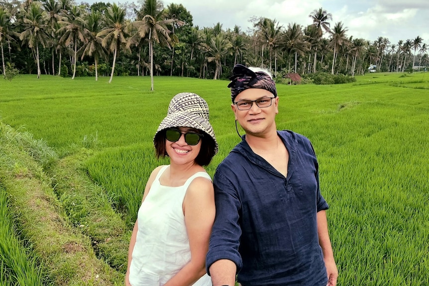 Rahmadian Satari and his wife selfie in front of paddy fields