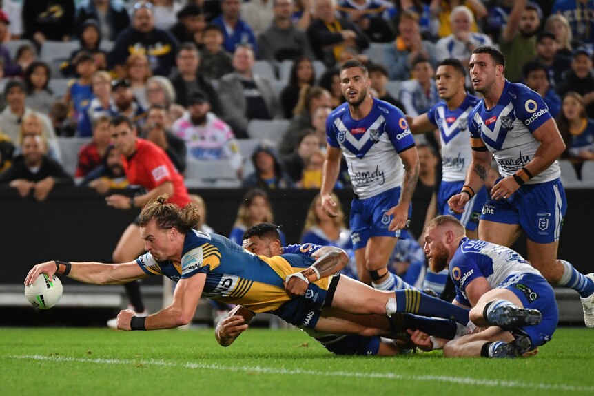 Parramatta Eels' Clint Gutherson stretches out to score a try against the Canterbury Bulldogs in their NRL game.