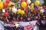 People with balloons celebrate in Manila after the UN rules China has no historic claim to the South China Sea.