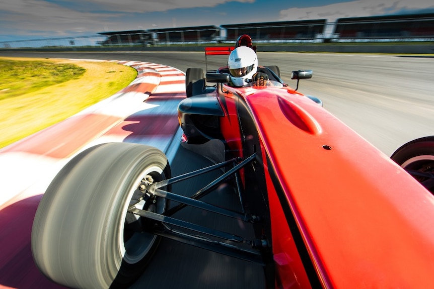 A driver whips around The Bend track at Tailem Bend in a Formula 1 car.