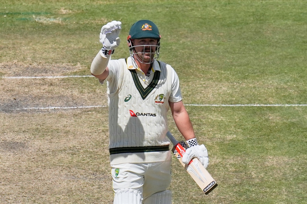Travis Head holds up his hand